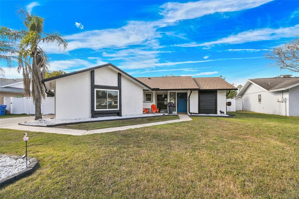 a view of a house with pool and chairs