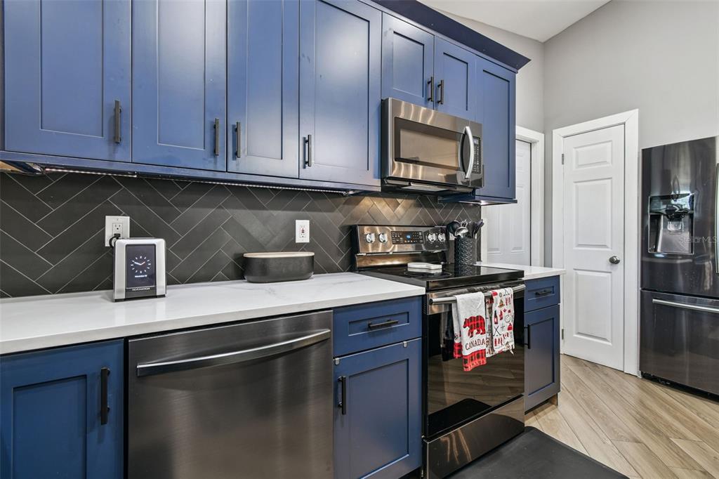 1729 Lakecrest Avenue Brandon, FL 33510 - Photo 15 of 51 a kitchen with stainless steel appliances granite countertop a stove a refrigerator and a microwave