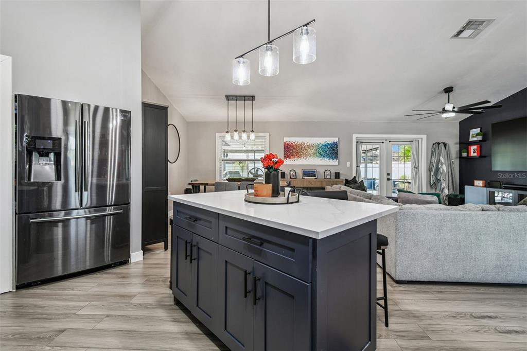 1729 Lakecrest Avenue Brandon, FL 33510 - Photo 16 of 51 a kitchen with stainless steel appliances a sink a refrigerator a center island and wooden floor