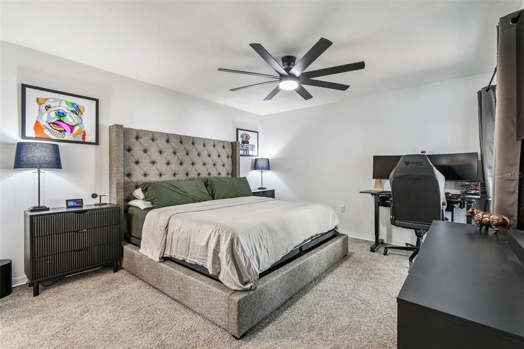 1729 Lakecrest Avenue Brandon, FL 33510 - Photo 19 of 51 a bedroom with a bed and a chandelier