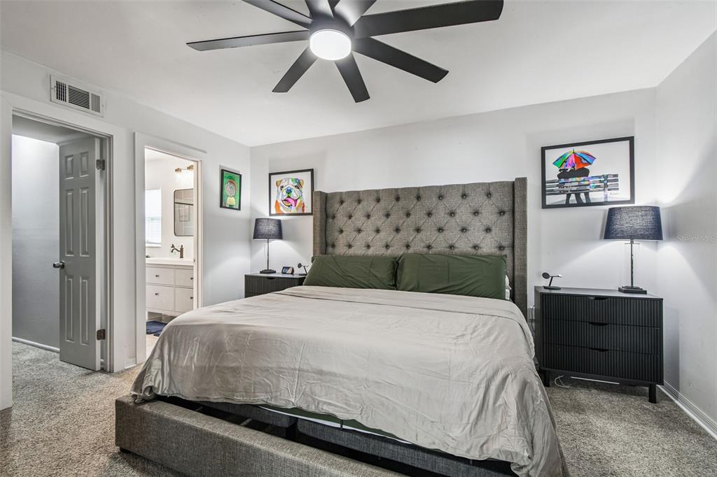 1729 Lakecrest Avenue Brandon, FL 33510 - Photo 20 of 51 a bedroom with a bed and a chandelier