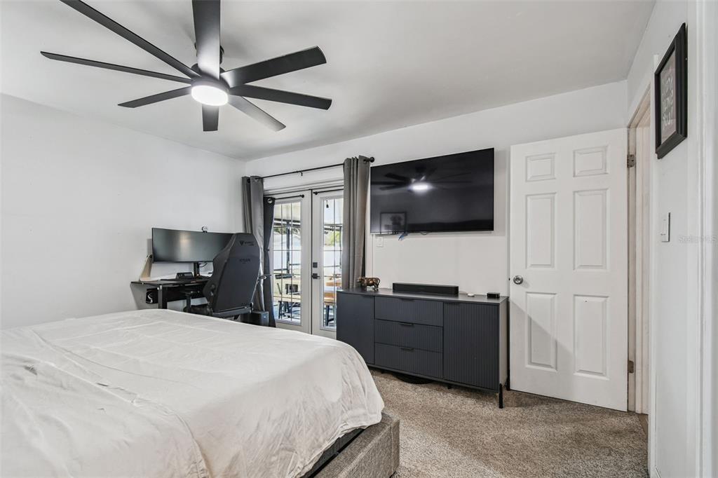 1729 Lakecrest Avenue Brandon, FL 33510 - Photo 23 of 51 a bedroom with a bed and a flat tv screen on dresser