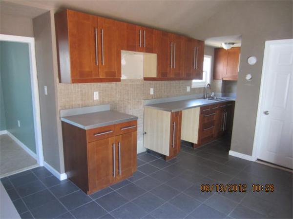 19 Marble Street Fall River, MA 02721 - Photo 14 of 30 a kitchen with stainless steel appliances granite countertop a sink stove and refrigerator