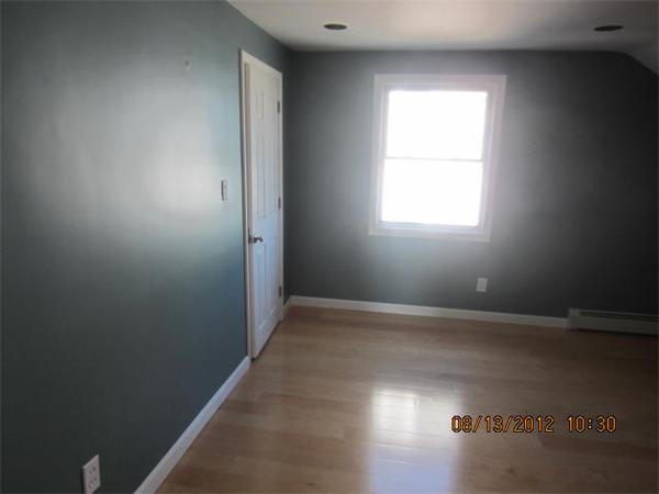 19 Marble Street Fall River, MA 02721 - Photo 26 of 30 an empty room with wooden floor and windows