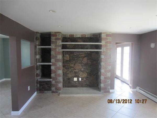 19 Marble Street Fall River, MA 02721 - Photo 9 of 30 a view of empty room with window and fireplace