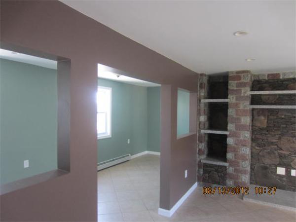 19 Marble Street Fall River, MA 02721 - Photo 10 of 30 a view of an empty room with a fireplace