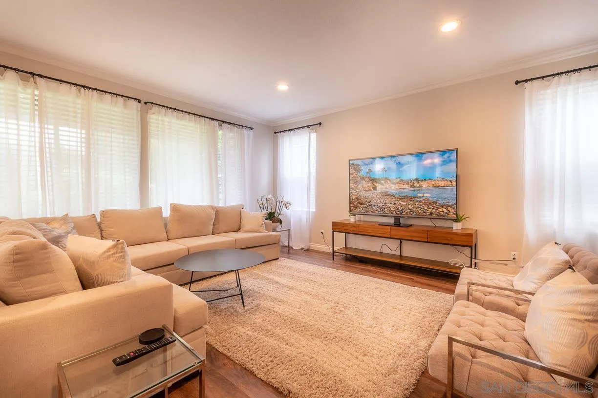 2435 Ridgegate Row La Jolla, CA 92037 - Photo 11 of 30 a living room with furniture and a flat screen tv
