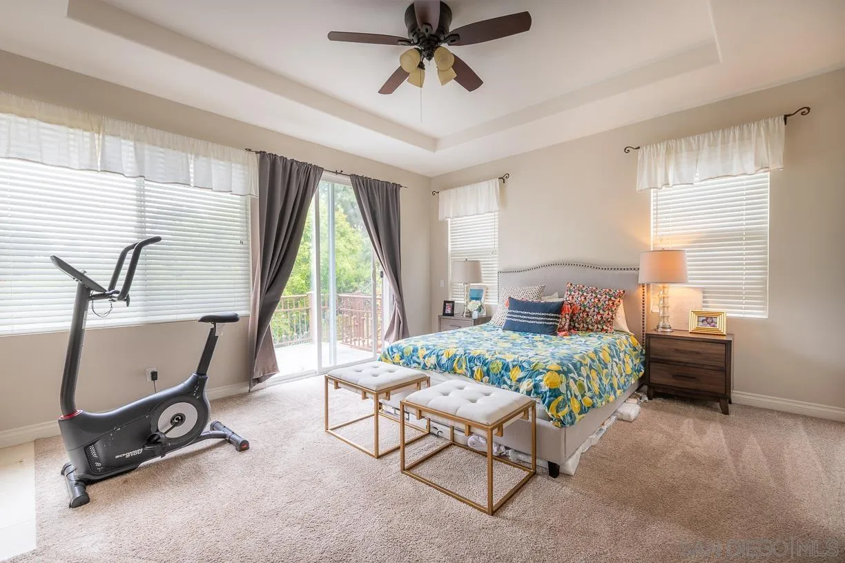 2435 Ridgegate Row La Jolla, CA 92037 - Photo 15 of 30 a bedroom with a bed a desk and chair