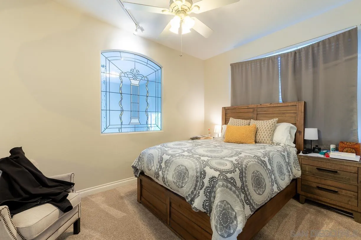 2435 Ridgegate Row La Jolla, CA 92037 - Photo 17 of 30 a bedroom with a bed and window
