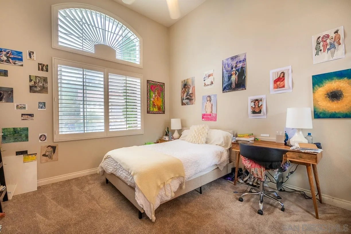2435 Ridgegate Row La Jolla, CA 92037 - Photo 19 of 30 a bedroom with a bed and a window