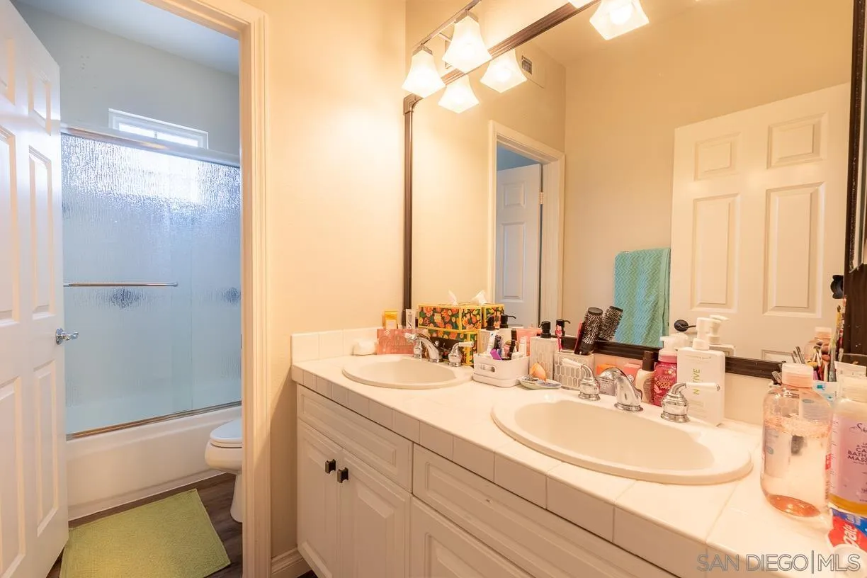 2435 Ridgegate Row La Jolla, CA 92037 - Photo 20 of 30 a bathroom with double vanity and a bathtub