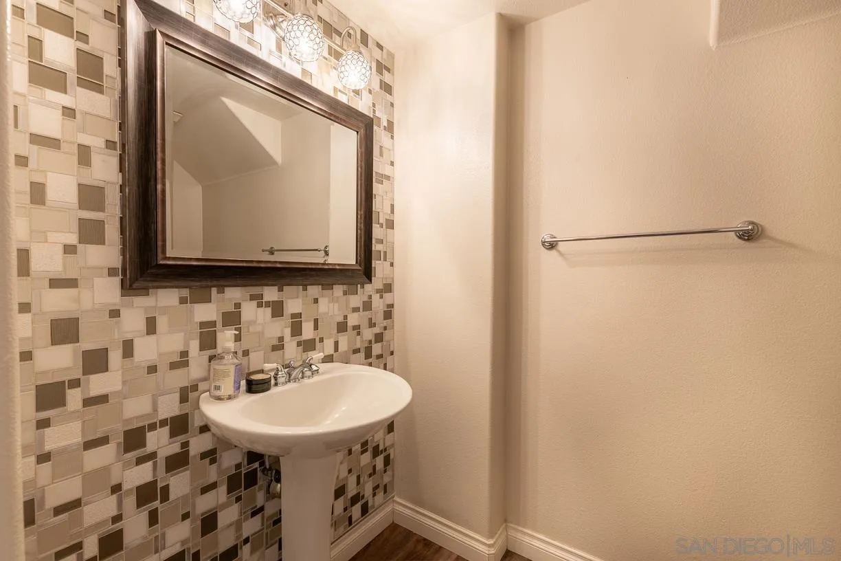 2435 Ridgegate Row La Jolla, CA 92037 - Photo 23 of 30 a bathroom with a sink and a mirror