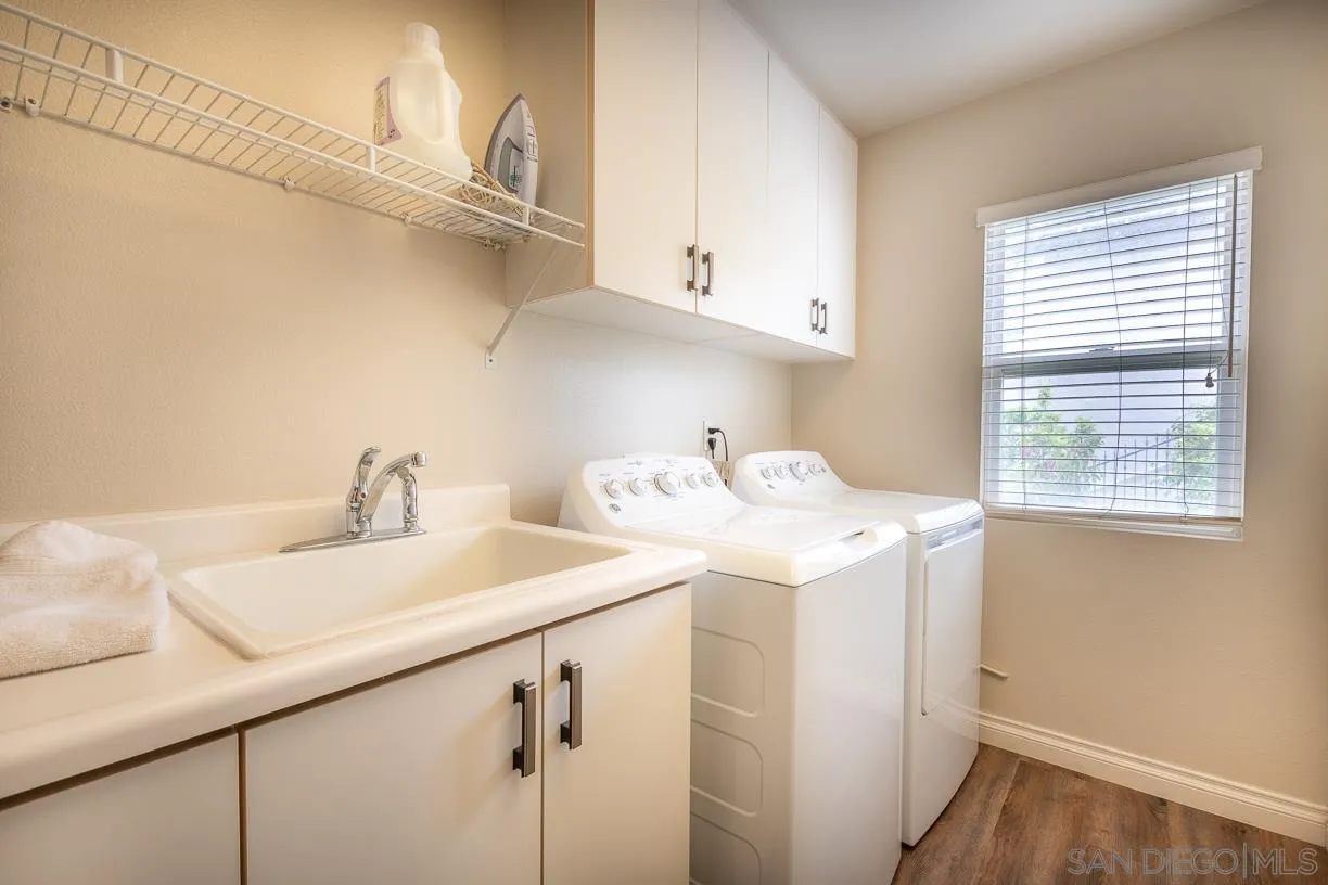 2435 Ridgegate Row La Jolla, CA 92037 - Photo 24 of 30 a utility room with cabinets washer and dryer