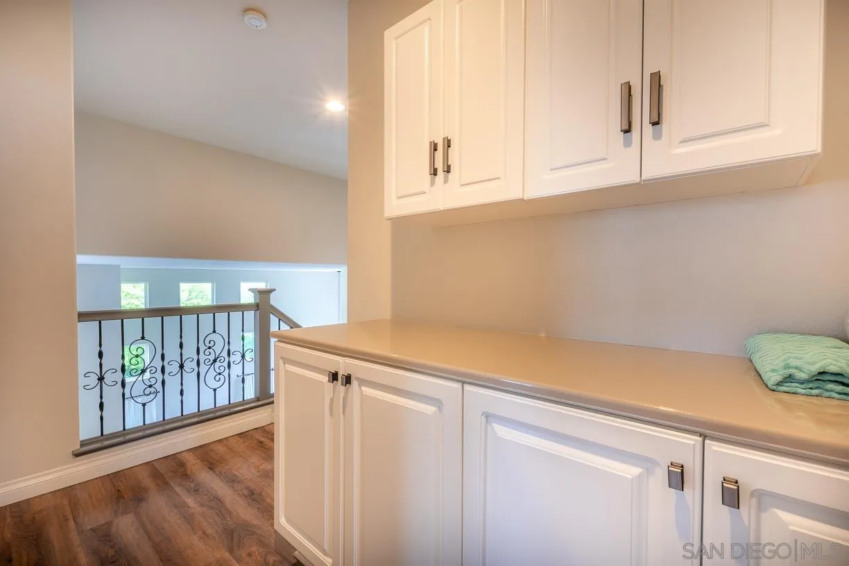 2435 Ridgegate Row La Jolla, CA 92037 - Photo 25 of 30 a view of cabinets with wooden floor