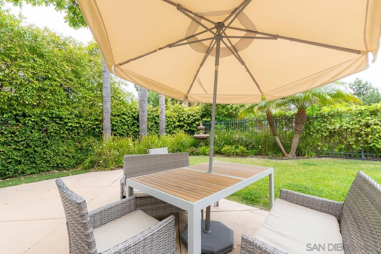 2435 Ridgegate Row La Jolla, CA 92037 - Photo 28 of 30 a view of a patio with a table and chairs under an umbrella