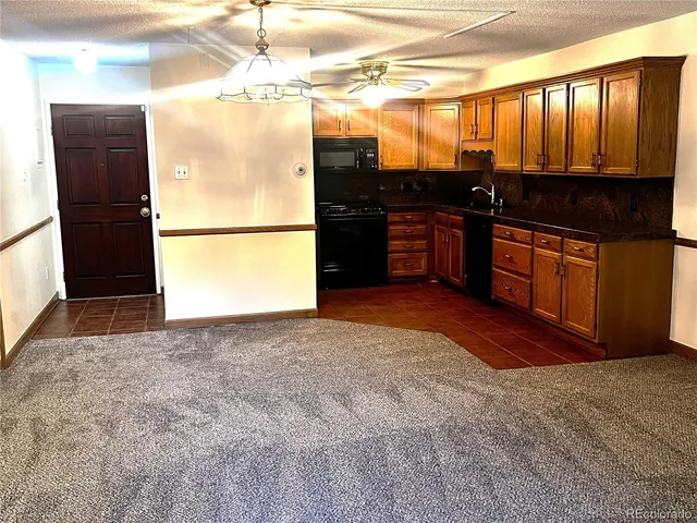 a kitchen with stainless steel appliances granite countertop a refrigerator and a stove