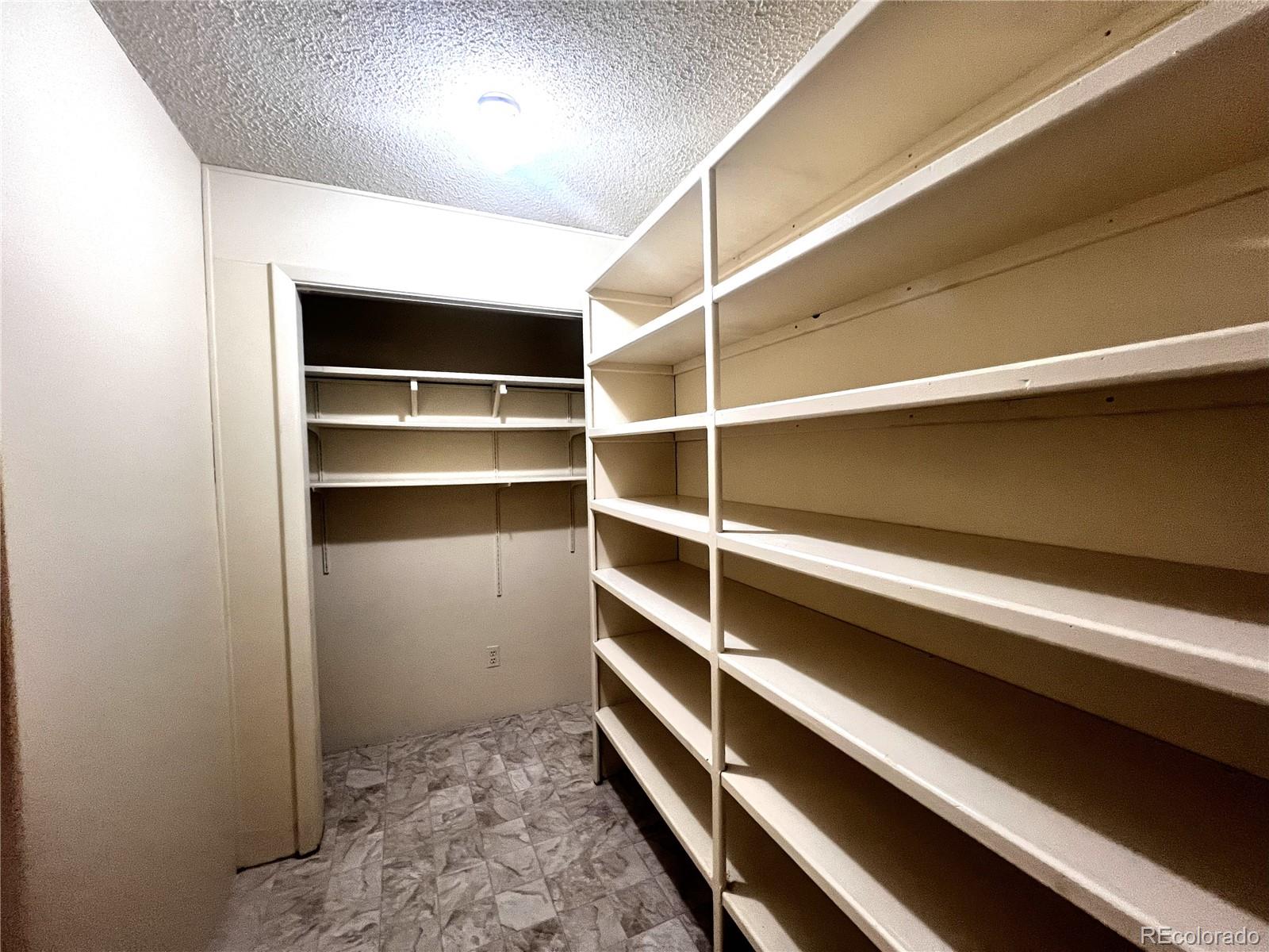 3082 South Wheeling Way, Unit 104 Aurora, CO 80014 - Photo 9 of 27 a view of walk in closet with empty racks