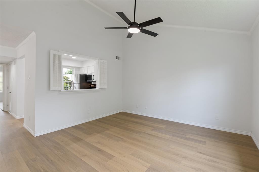 5300 Keller Springs Road, Unit 2042 Dallas, TX 75248 - Photo 7 of 28 Living room with vaulted ceiling and window to kitchen