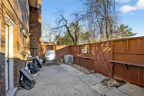 a view of a house with backyard and wooden fence