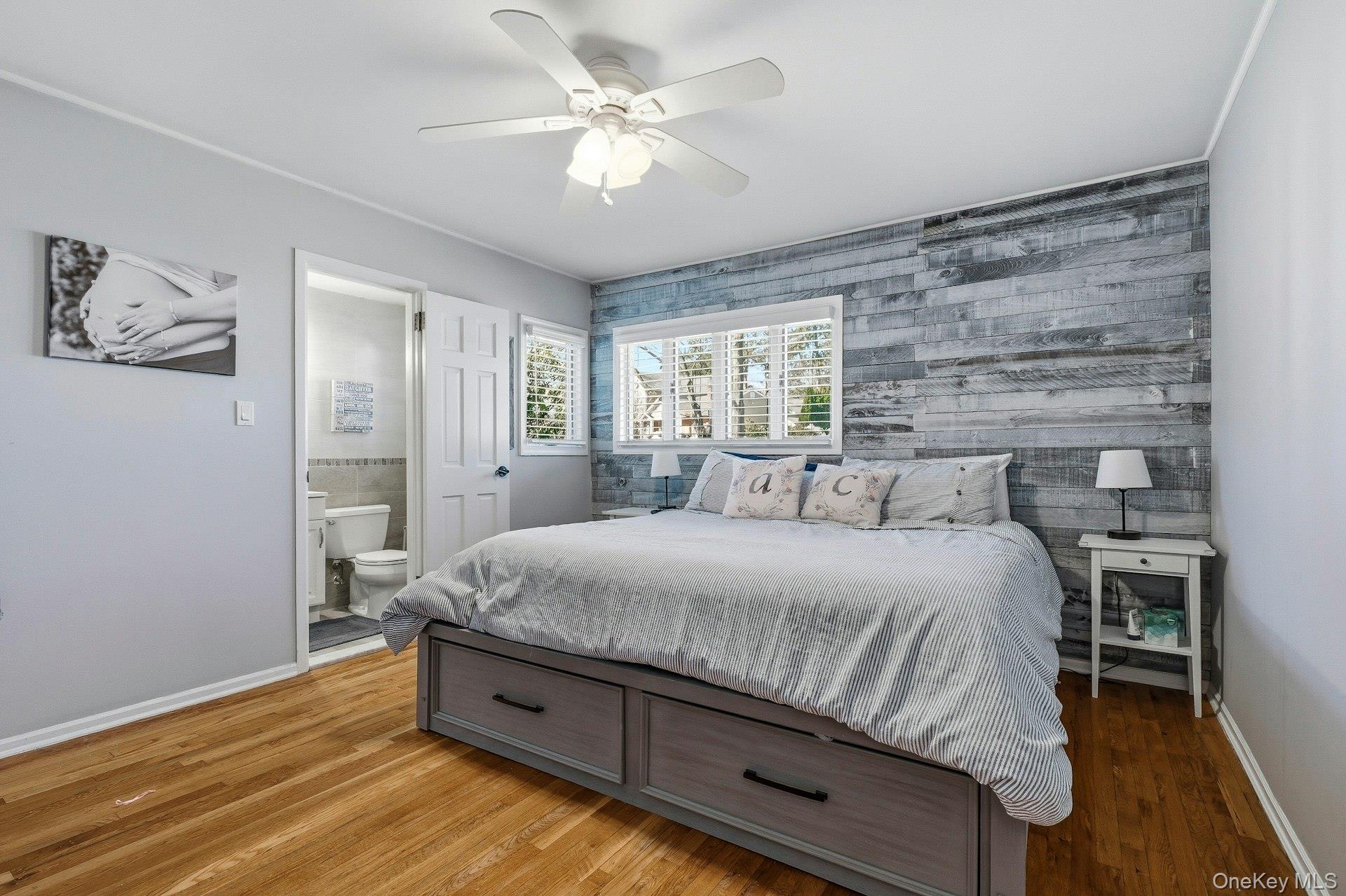 12 Sherman Road Glen Cove, NY 11542 - Photo 12 of 27 a spacious bedroom with a bed and a chandelier