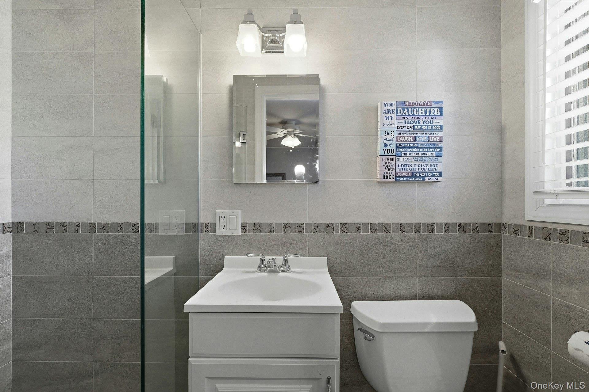 12 Sherman Road Glen Cove, NY 11542 - Photo 13 of 27 a bathroom with a toilet sink and mirror