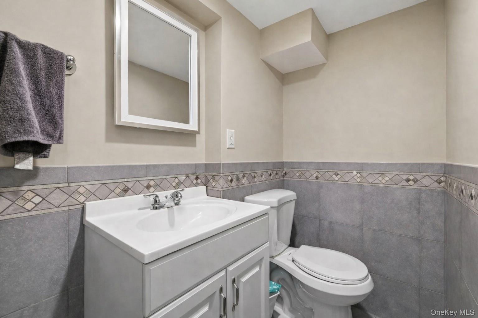 12 Sherman Road Glen Cove, NY 11542 - Photo 24 of 27 a bathroom with a sink mirror and toilet