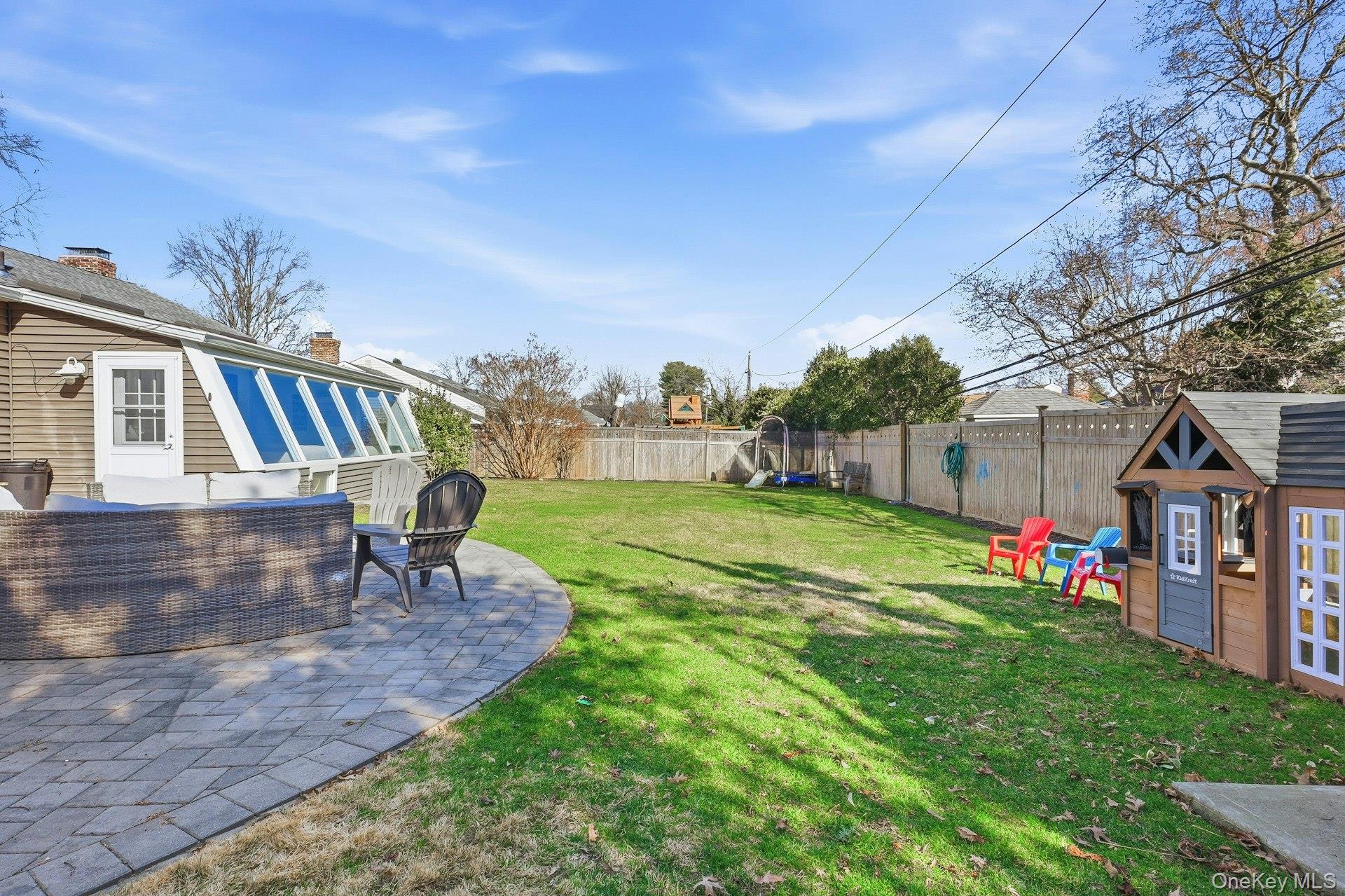 12 Sherman Road Glen Cove, NY 11542 - Photo 25 of 27 a view of a house with backyard and a tree
