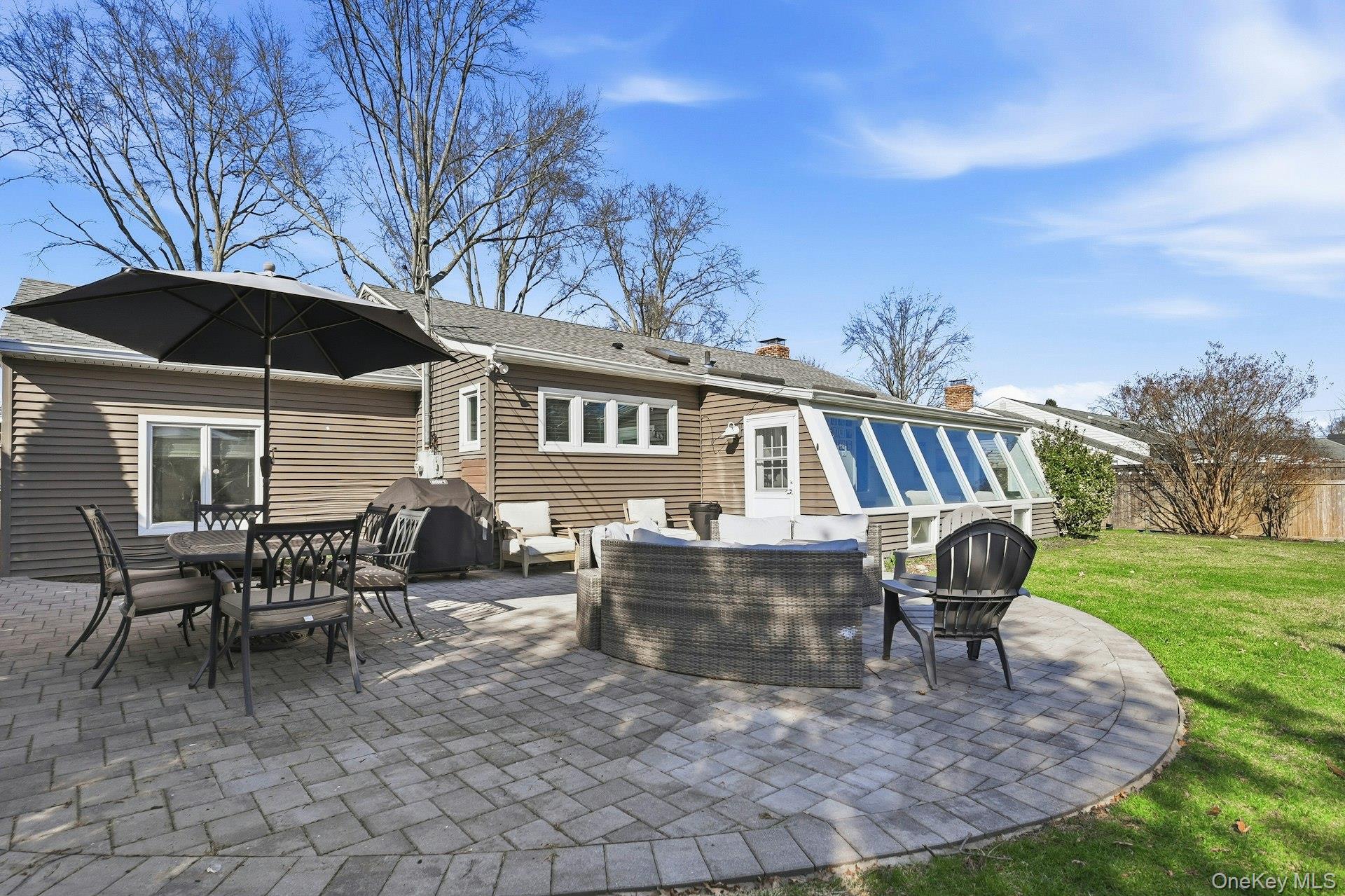 12 Sherman Road Glen Cove, NY 11542 - Photo 3 of 27 a view of a house with backyard porch and sitting area