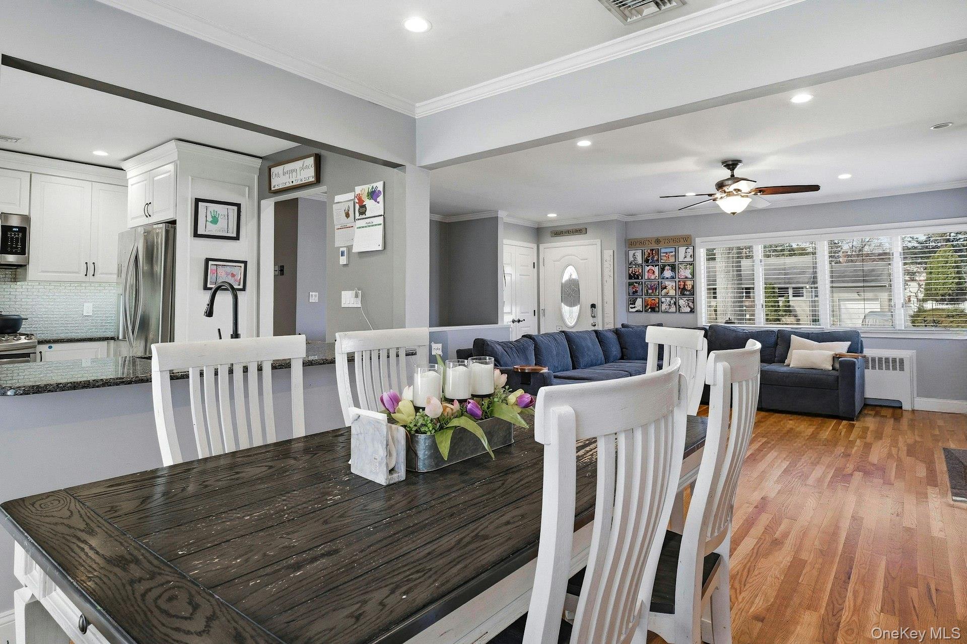 12 Sherman Road Glen Cove, NY 11542 - Photo 5 of 27 a view of a dining room with furniture a chandelier and wooden floor