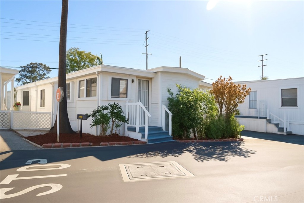 a view of a house with a tree in front of it