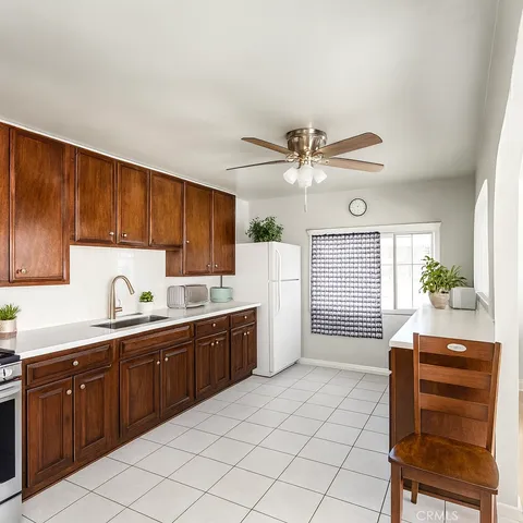 a kitchen with a sink cabinets and window