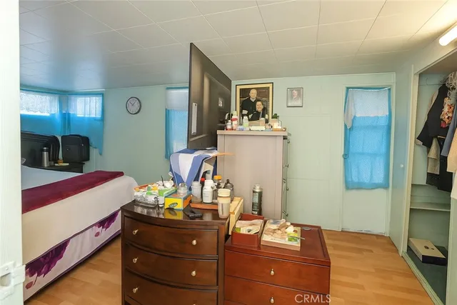 a room with a bed and a mirror on the dresser