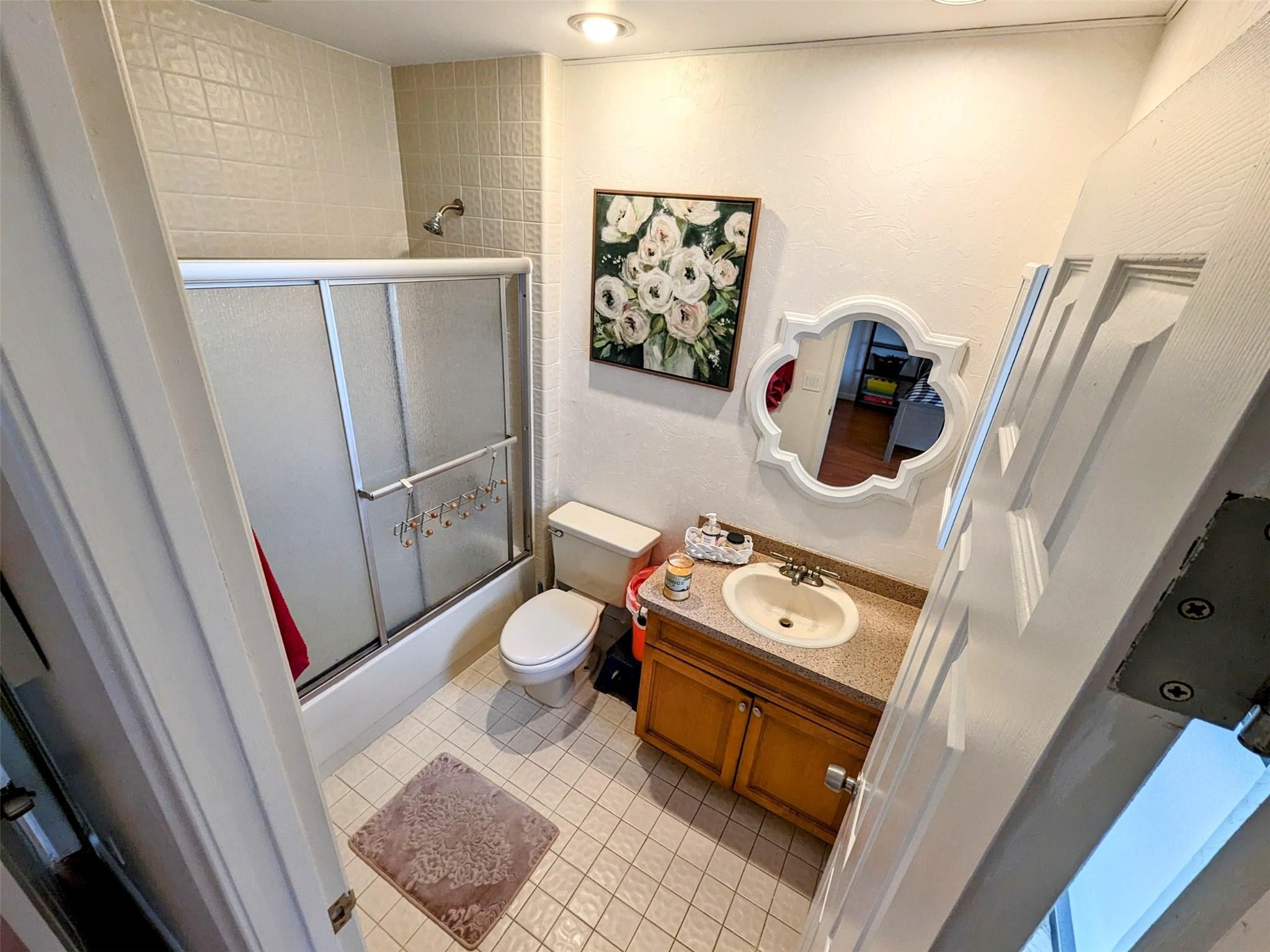 5762 Fox Hollow Drive, Unit G Boca Raton, FL 33486 - Photo 29 of 53 a bathroom with a toilet a sink and a mirror