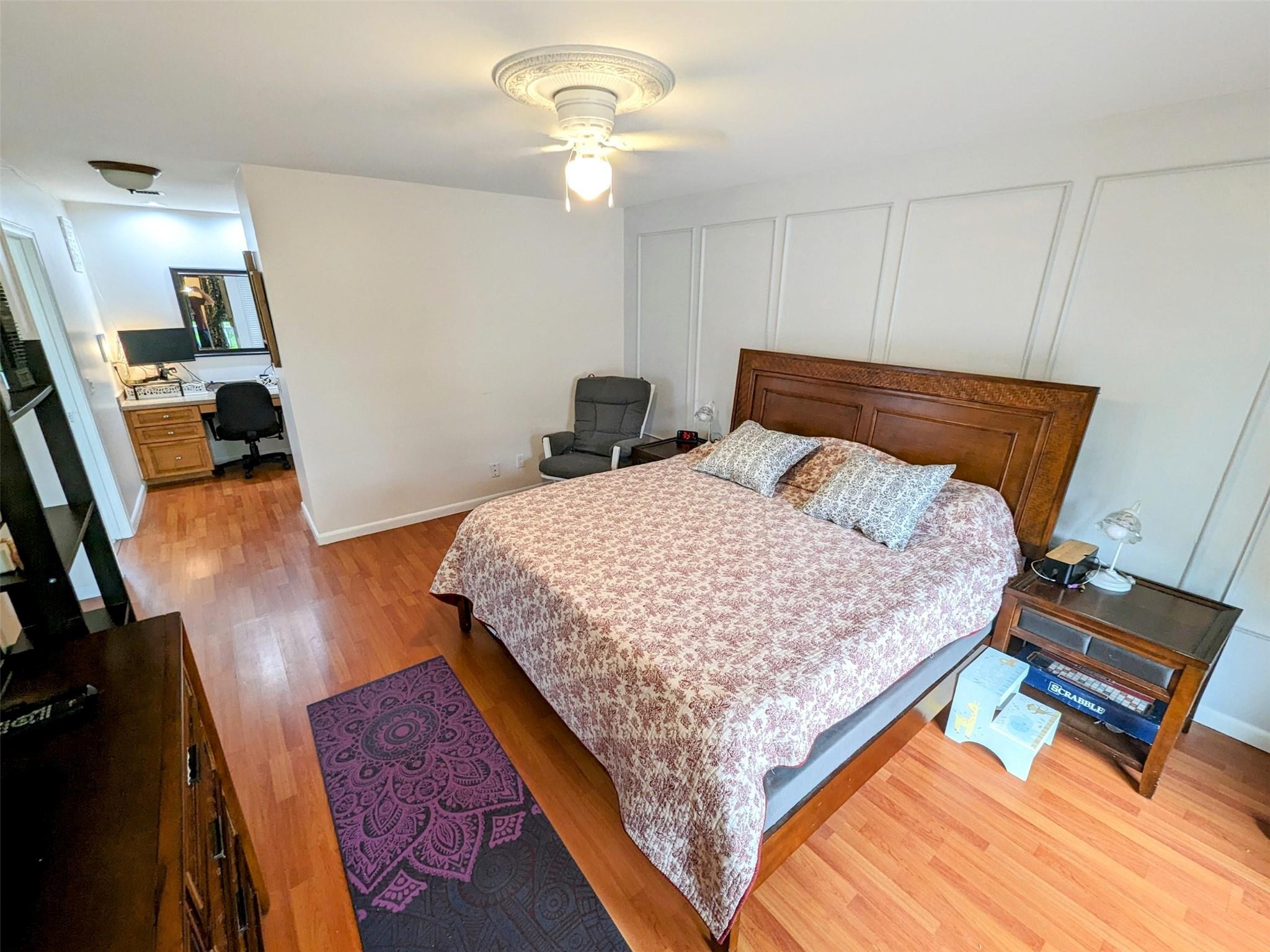 5762 Fox Hollow Drive, Unit G Boca Raton, FL 33486 - Photo 32 of 53 a bed sitting in a bedroom next to a window with pc on the table
