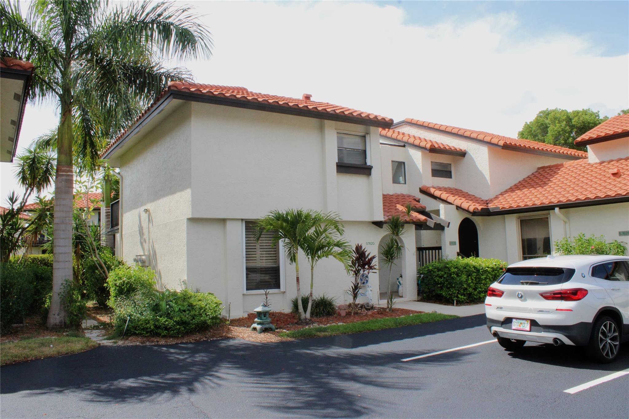 5762 Fox Hollow Drive, Unit G Boca Raton, FL 33486 - Photo 5 of 53 a car parked in front of white house