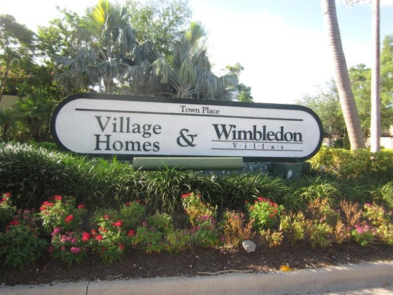 5762 Fox Hollow Drive, Unit G Boca Raton, FL 33486 - Photo 7 of 53 a sign broad in front of flowers