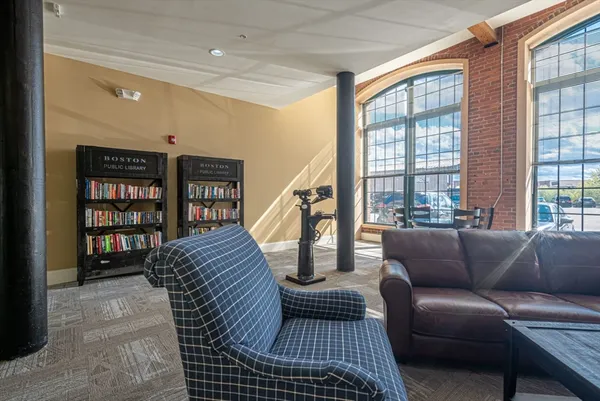 a living room with furniture and a book shelf
