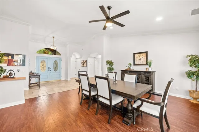 a living room with furniture a rug a fireplace and a large window