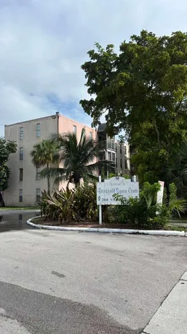 a living room with a flat screen tv and a glass door