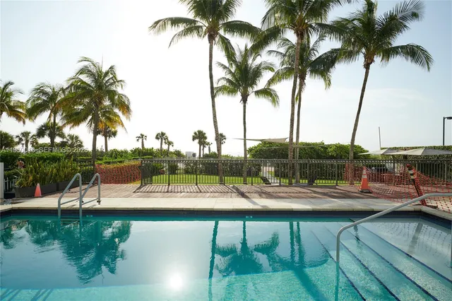 a view of a swimming pool with a table and chairs