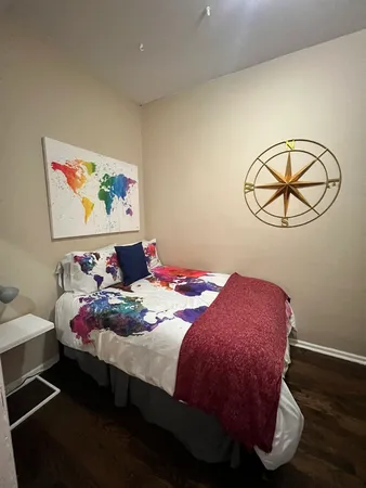a bedroom with a bed and a chandelier