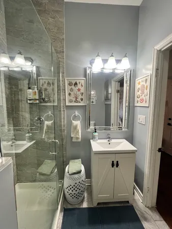 a bathroom with a sink a toilet and shower