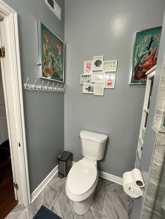 a white toilet sitting next to a bathroom sink