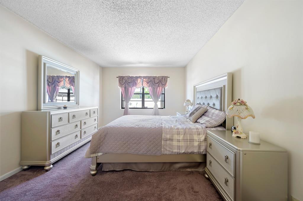 1301 Northeast 7th Street, Unit 113 Hallandale Beach, FL 33009 - Photo 13 of 45 a bedroom with a bed and a window