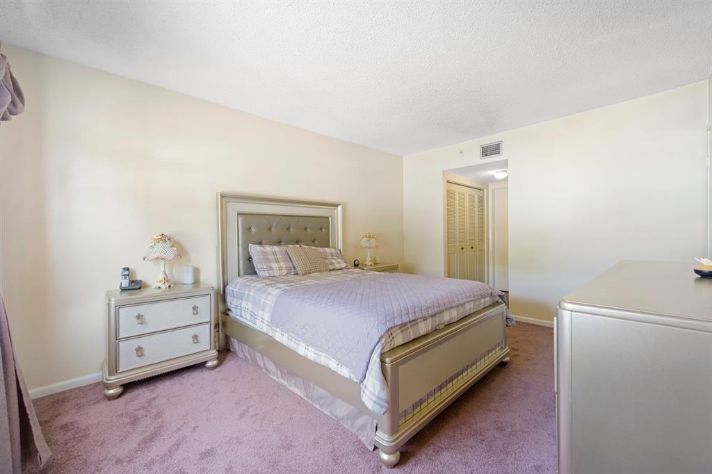 1301 Northeast 7th Street, Unit 113 Hallandale Beach, FL 33009 - Photo 14 of 45 a bedroom with a bed and a cabinets