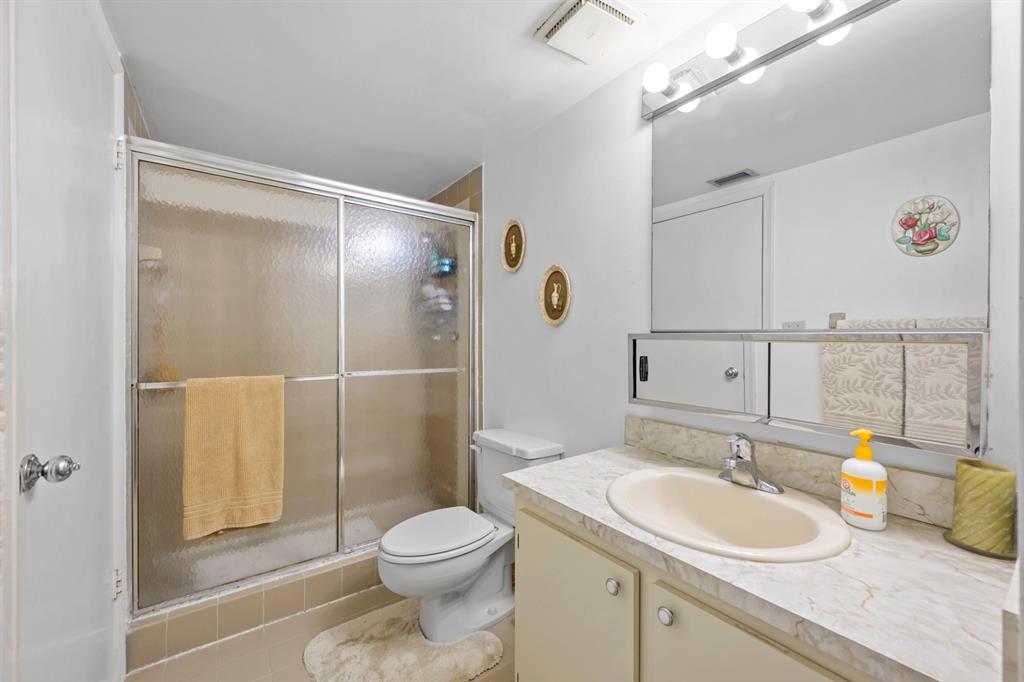 1301 Northeast 7th Street, Unit 113 Hallandale Beach, FL 33009 - Photo 15 of 45 a bathroom with a sink toilet and shower