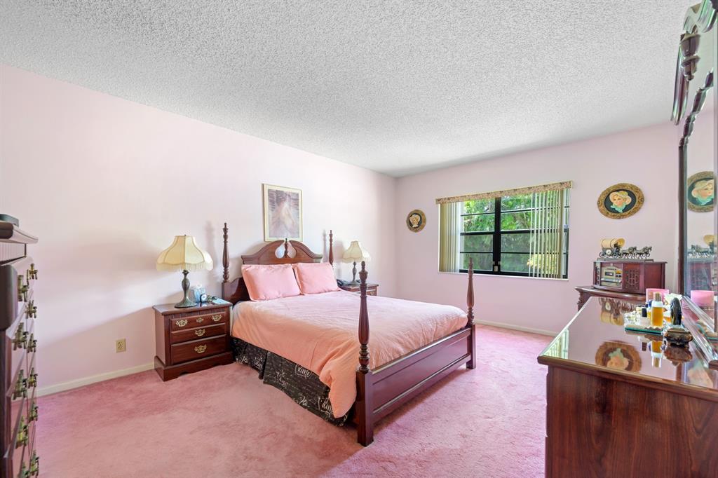 1301 Northeast 7th Street, Unit 113 Hallandale Beach, FL 33009 - Photo 17 of 45 a bedroom with a bed and a window