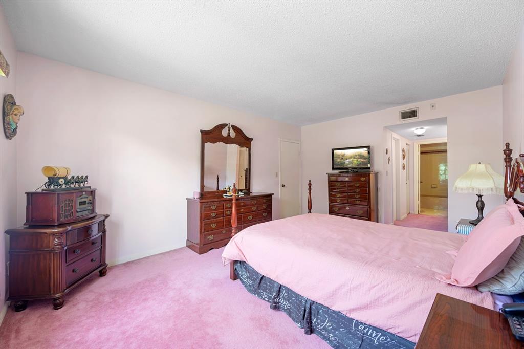 1301 Northeast 7th Street, Unit 113 Hallandale Beach, FL 33009 - Photo 18 of 45 a large bedroom with a bed and dresser