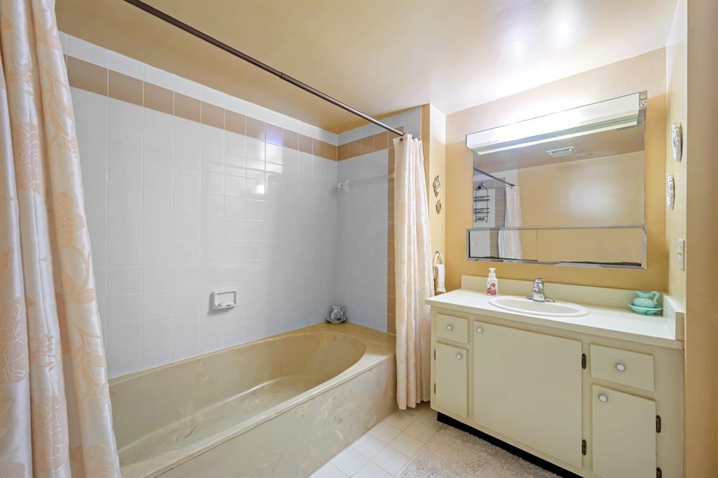 1301 Northeast 7th Street, Unit 113 Hallandale Beach, FL 33009 - Photo 20 of 45 a bathroom with a tub a sink and mirror