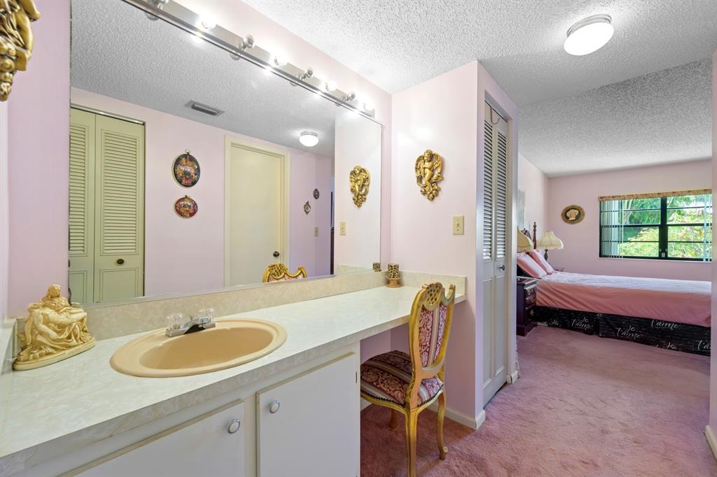 1301 Northeast 7th Street, Unit 113 Hallandale Beach, FL 33009 - Photo 21 of 45 a bathroom with a granite countertop sink and a mirror